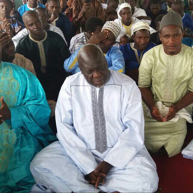 Spiritualist Danso praying with other